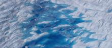 Image of a blue melt pond on a glacier